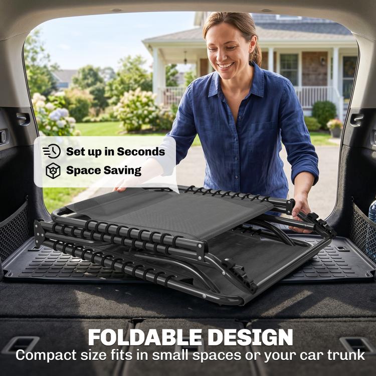 Gray folding chaise lounge chair partially unfolded in an open vehicle trunk