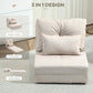 Beige floor sofa bed with tufted back cushion and two pillows