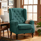 Dark green upholstered wingback lounge chair with button-tufted back and turned wood legs