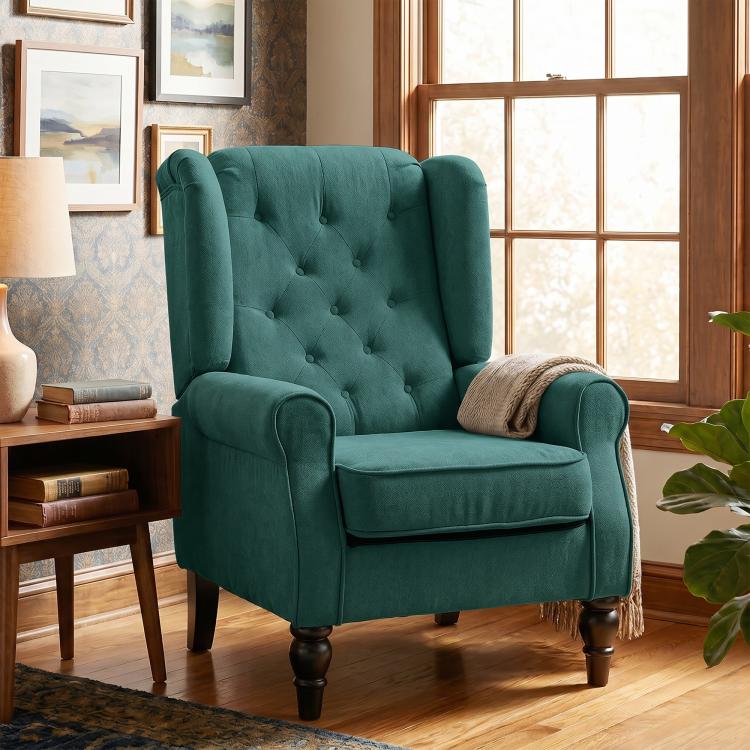 Dark green upholstered wingback lounge chair with button-tufted back and turned wood legs