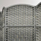 Close-up of gray woven privacy screen with arched edge and crisscross pattern