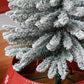 Snow-frosted artificial Christmas tree branches on metal stand frame