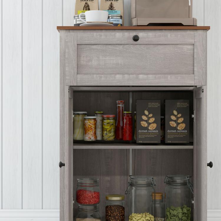 Open sideboard cabinet doors showing shelves with jars, bottles, and pantry items