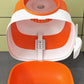 White and orange dome cat litter box with hinged lid and front access opening