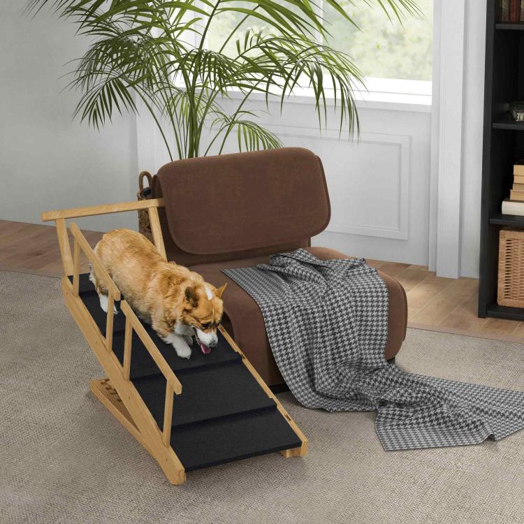 Pet ramp with black non-slip steps and wooden guardrails beside a couch