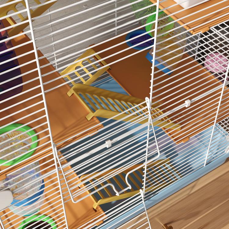 Close-up of multi-level hamster cage with wooden ramps and white wire grid