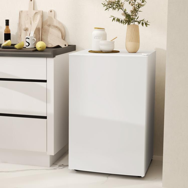 White mini fridge with door closed, compact upright appliance
