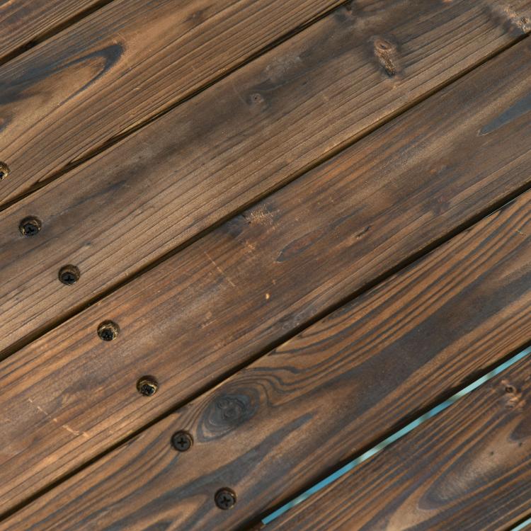 Carbonized fir wood bridge planks with dark finish and metal fasteners