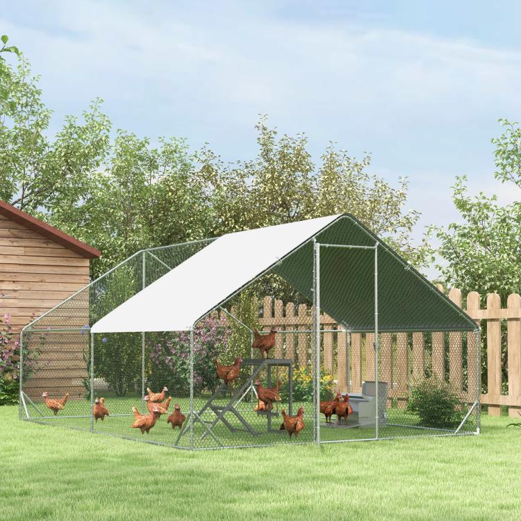 Outdoor gray chicken play activity center inside a fenced coop with ladder and swing