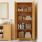 Pinewood pantry cabinet doors open, displaying stacked dishes, towels, bottles, and basket storage
