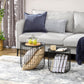Round black wire coffee tables with dark tops, shown in front of a light gray sofa