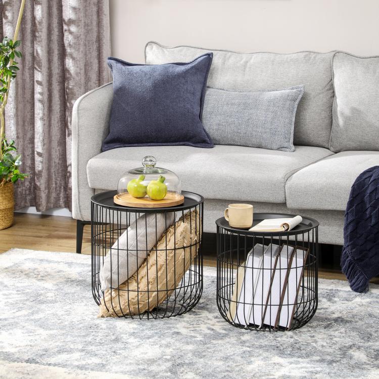 Round black wire coffee tables with dark tops, shown in front of a light gray sofa