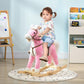 Pink plush rocking horse ride-on with child seated, wooden rocker base and bridle