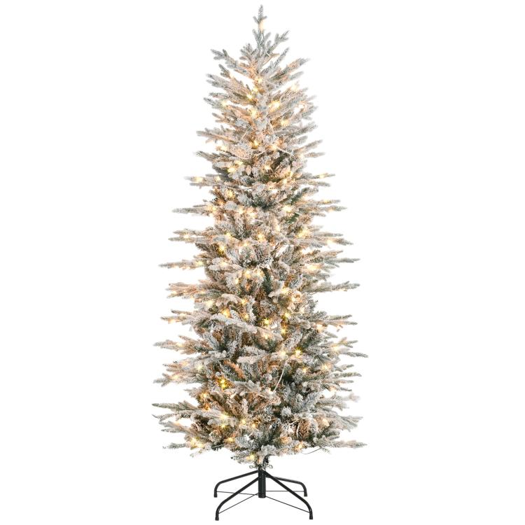Artificial flocked Christmas tree with warm clear lights and snowy full branches