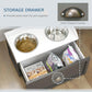 Gray pet feeding station with open storage drawer holding pet supplies and two bowls