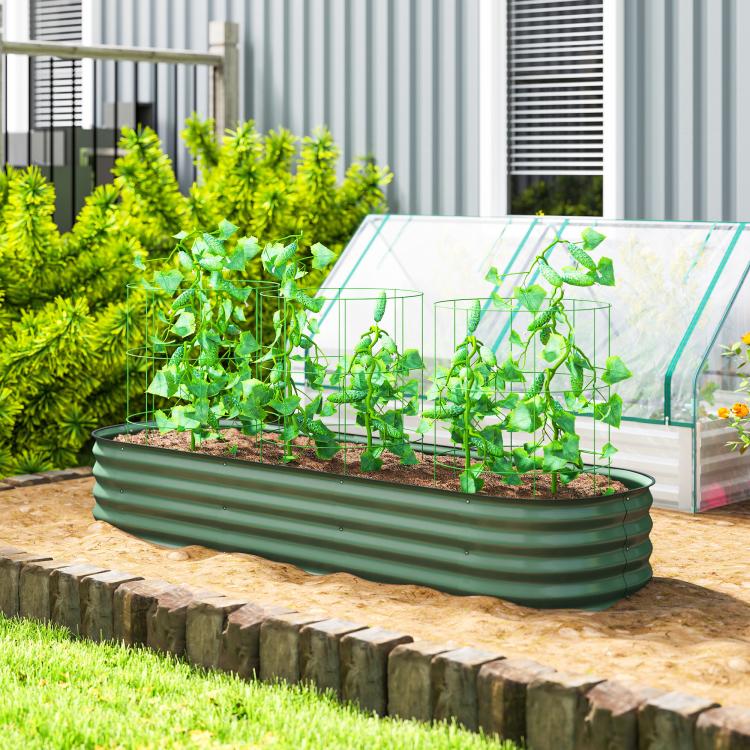 Green metal raised garden bed planter with seedlings and an attached clear cover