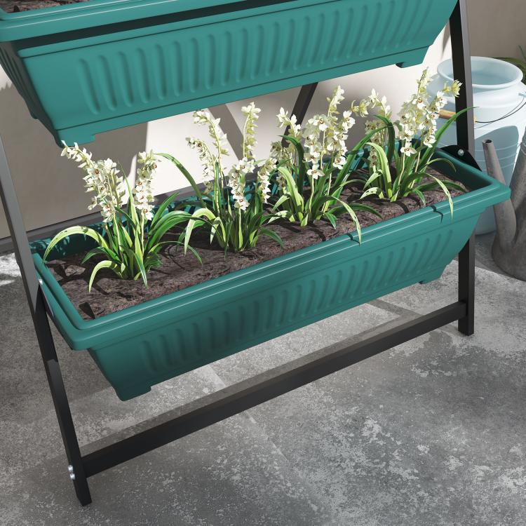 Green 4-tier vertical raised planter on black stand with soil and flowers