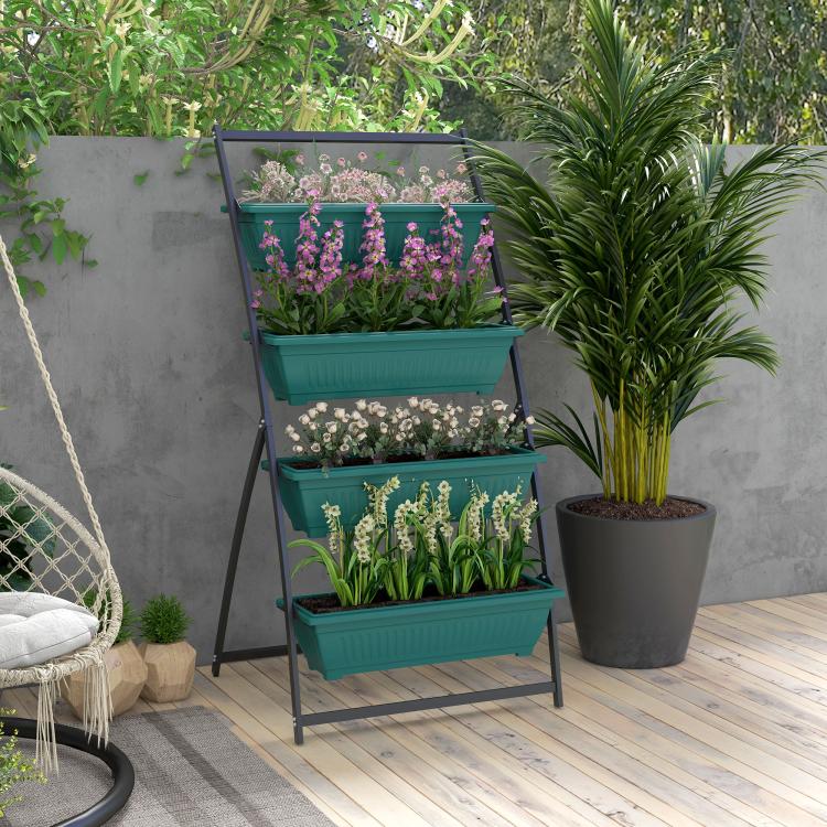 Outdoor 4-tier green raised planter with flowering plants on a wooden deck