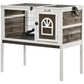 Elevated rabbit hutch with wire side gate, front door, and dark interior ramp