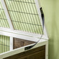 Close-up of rabbit hutch wire grid and latch on white frame corner