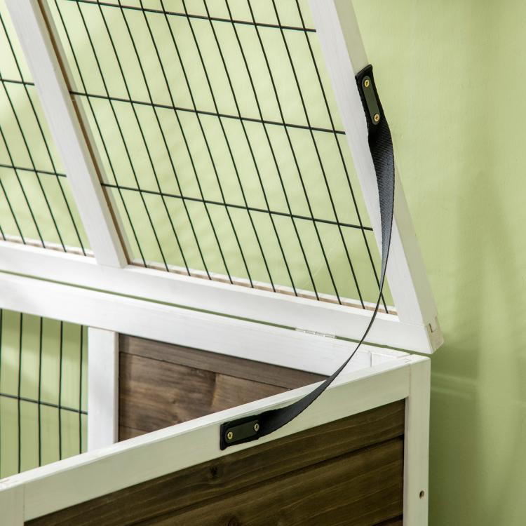 Close-up of rabbit hutch wire grid and latch on white frame corner