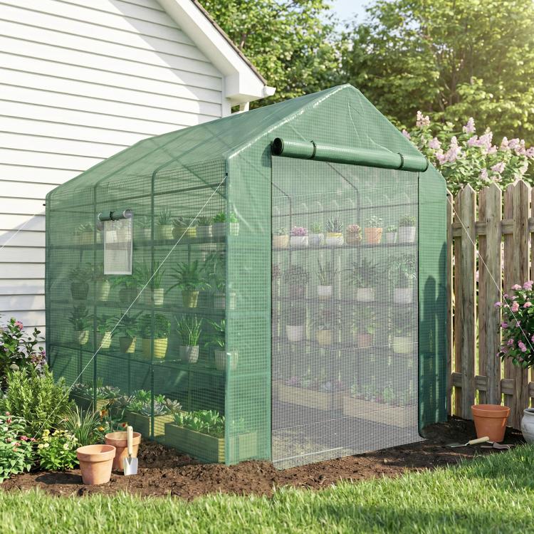 Green mesh greenhouse with roll-up zip door and window panels for protecting potted plants