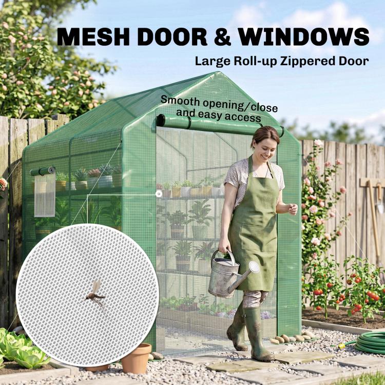 Green mesh greenhouse with large roll-up zip door and side windows for easy access