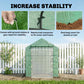 Green mesh greenhouse with ground stakes and ropes for added stability