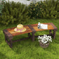 Wooden outdoor tree bench with dark brown slatted seat in a patio garden setting
