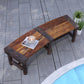 Wooden outdoor tree bench with dark brown slatted seat on a tiled patio