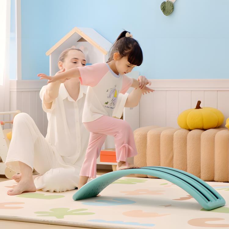Blue balance wobble board with curved ramps and textured grip surface