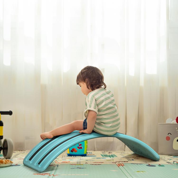 Turquoise-blue balance board with curved center ramp for standing play