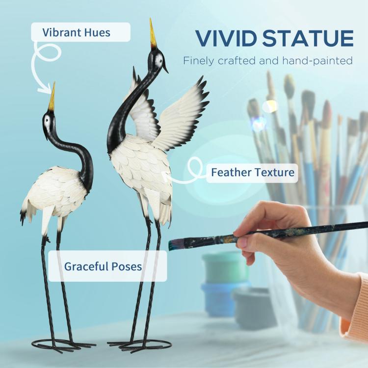 Hand-painted metal heron sculptures in black and white with detailed feather texture