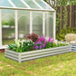 Silver galvanized raised garden bed planter with blooming flower plants