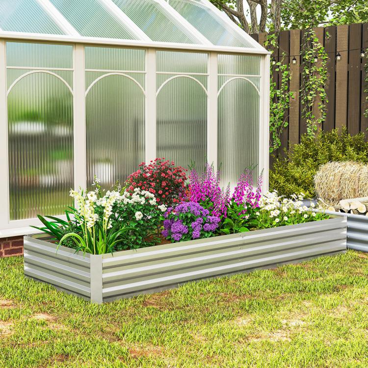 Silver galvanized raised garden bed planter with blooming flower plants