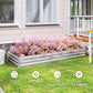 Silver galvanized raised garden bed planter with pink flowers on a lawn