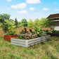 Silver galvanized raised garden bed planter with mixed plants in outdoor yard