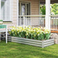 Silver galvanized raised garden bed planter with green foliage near a porch
