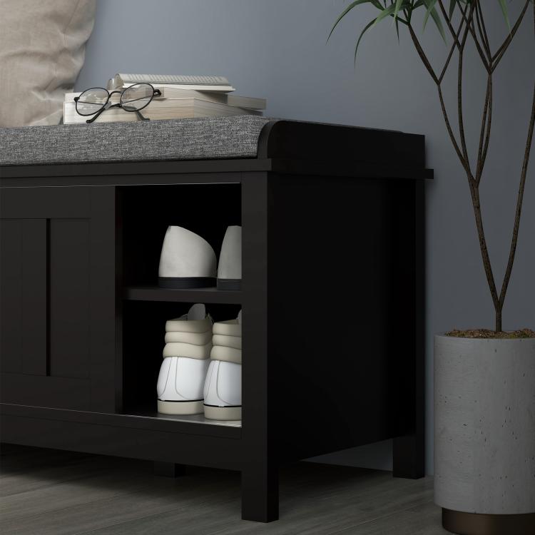 Black shoe storage bench with gray cushioned top, open cabinet for storing shoes