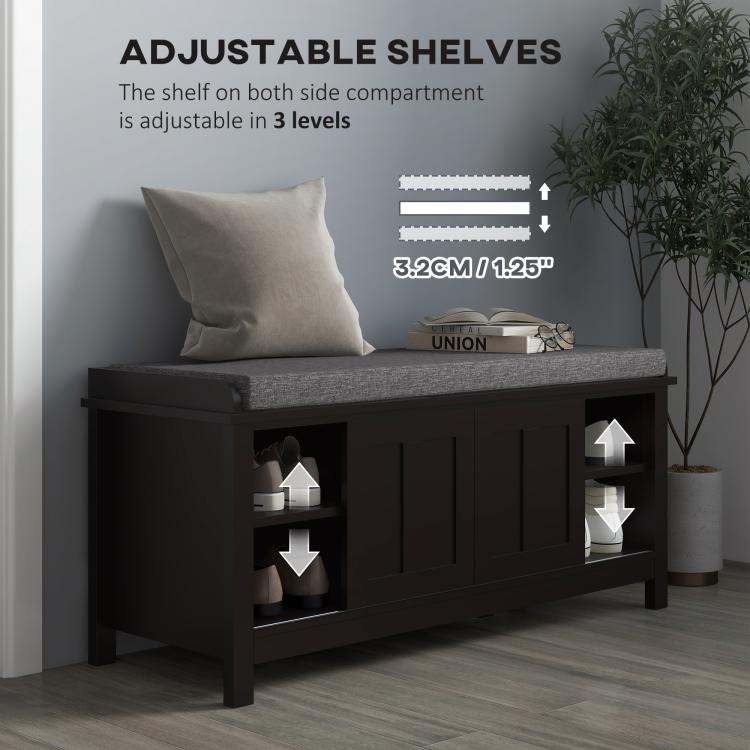 Black shoe storage bench with gray cushion and adjustable shelving inside