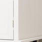 Close-up of metal cabinet hinge on distressed white kitchen island cart