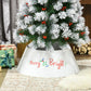 Cream white tree skirt collar on Christmas tree base with “Merry & Bright” front