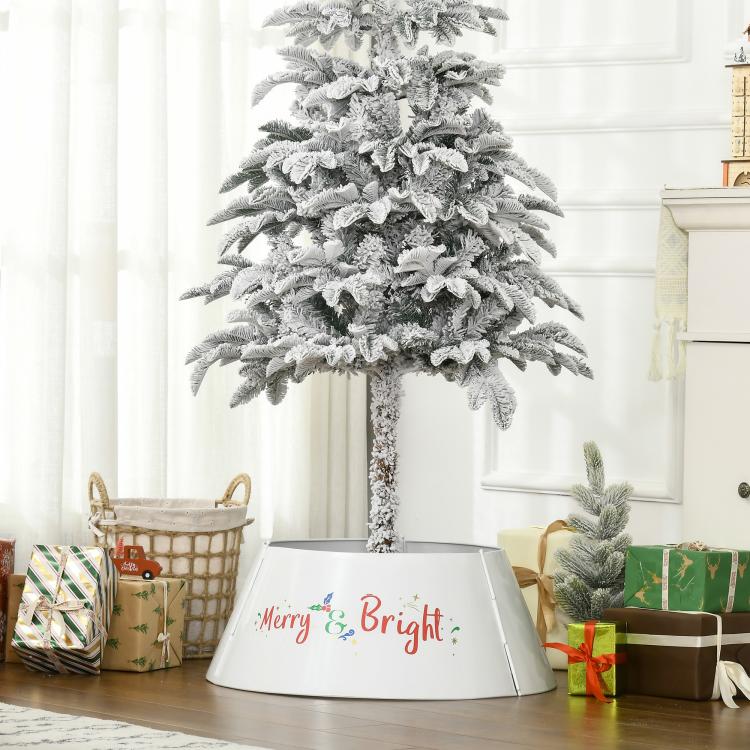 Cream white metal tree skirt collar under decorated tree with “Merry & Bright” front