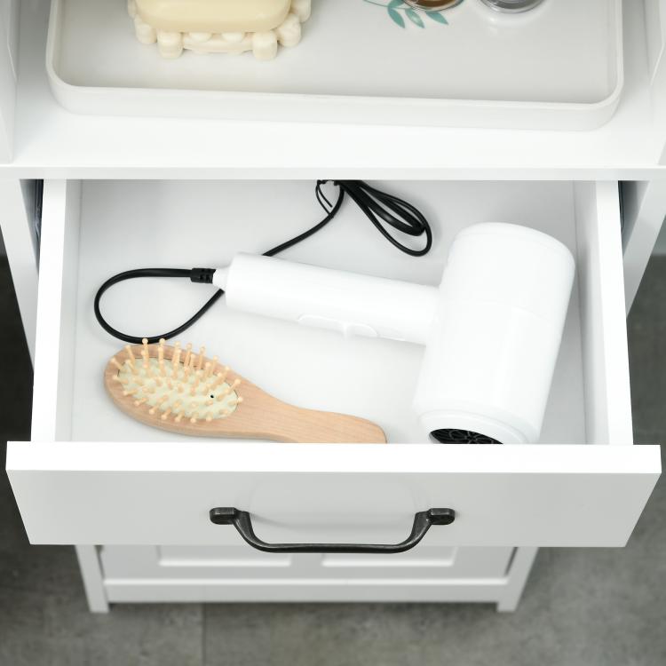 White pull-out drawer with black handle, holding hair brush and toiletries