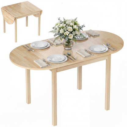 Natural wood drop-leaf dining table with oval top, set with plates and place settings