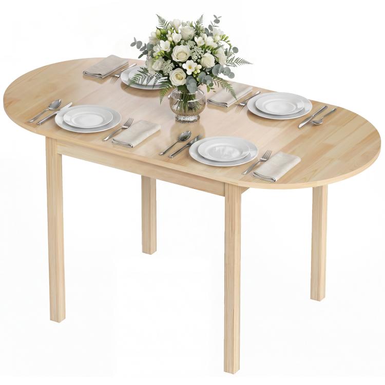 Natural wood oval drop-leaf dining table with dinnerware and center flower vase
