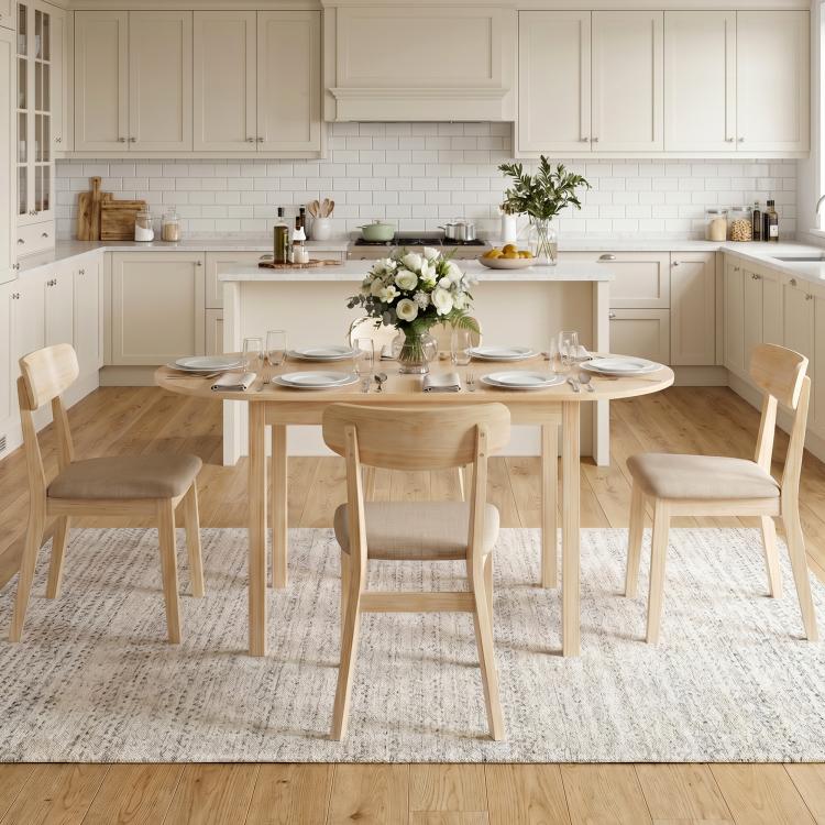 Natural wood drop-leaf dining table with place settings in a spacious kitchen
