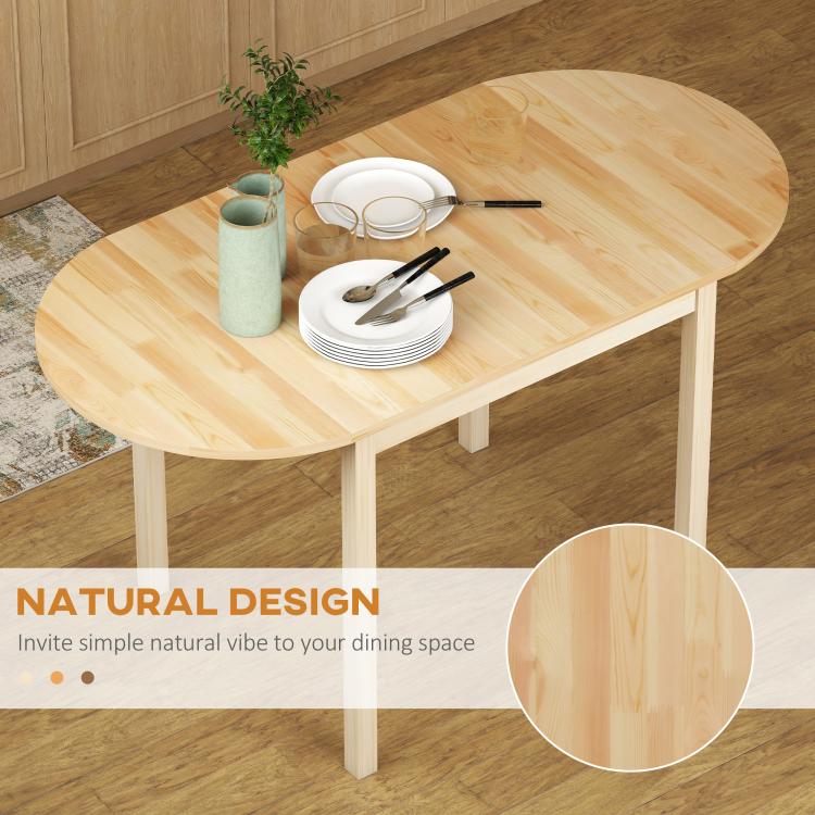 Natural wood drop-leaf dining table with partially open leaves and stacked plates