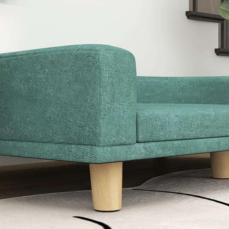 Green pet sofa bed close-up of upholstered corner and wooden leg