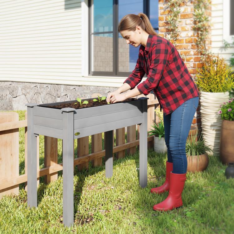 Dark gray elevated wooden raised garden bed with open top, resting on four legs